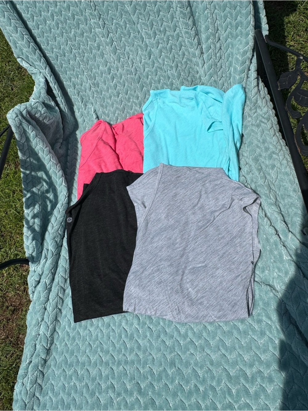 Set of four tops that have a twist in the front.